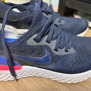 Nike woman’s “College Navy” Blue Knit Sneakers with Pink Accent Stripe